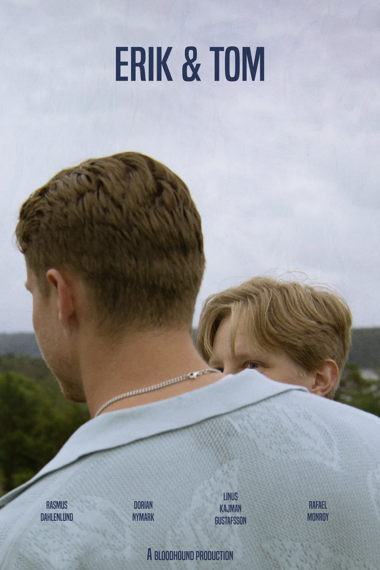 Erik & Tom film poster: a young man seen from behind, his younger brother looking over his shoulder