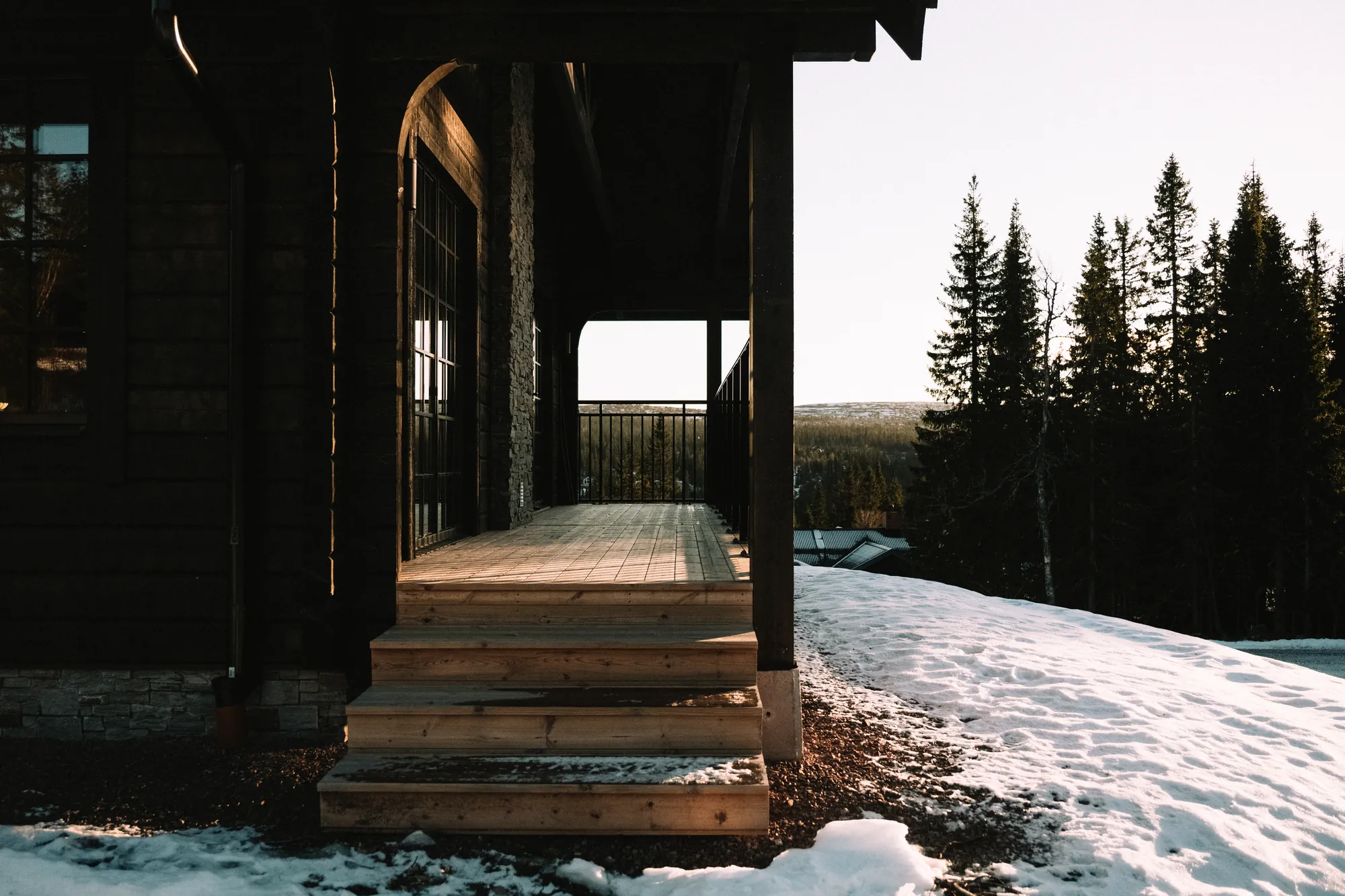 Warm evening light on the wooden steps of a cabin terrace
